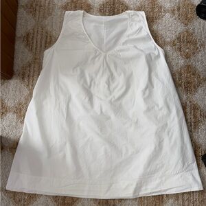 White Sleeveless V-Neck Cotton mini dress with side pockets.